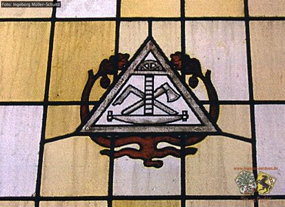 Fenster mit Zunftzeichen der Zimmerer Innung.